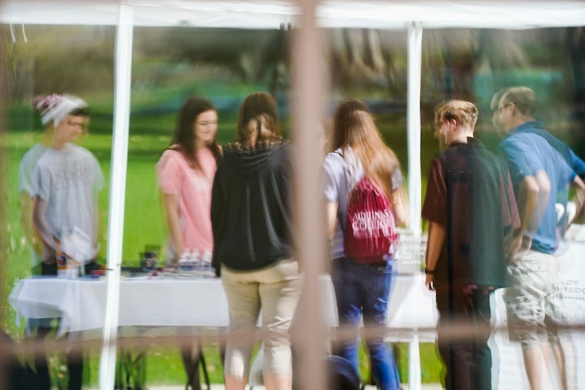 Students gathered around a table talking